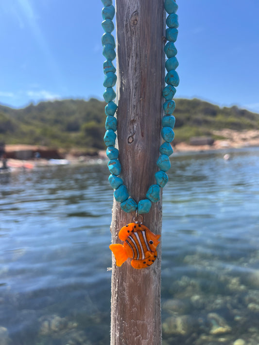 Orange fish and turquoise stones