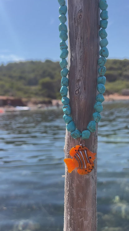 Orange fish and turquoise stones